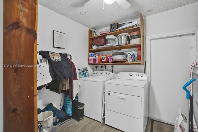 laundry room with laundry area, a textured ceiling, a ceiling fan, wood finished floors, and washer and clothes dryer