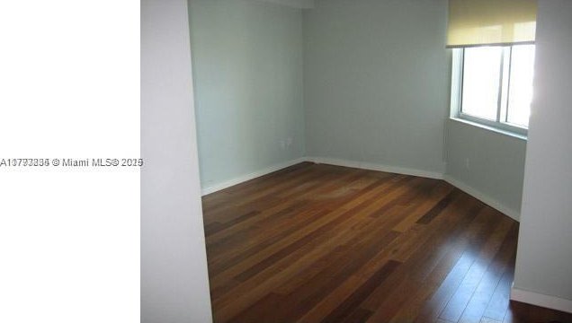 325 S Biscayne Blvd Unit 3822, Miami, FL 33131 - spare room featuring baseboards and hardwood / wood-style flooring