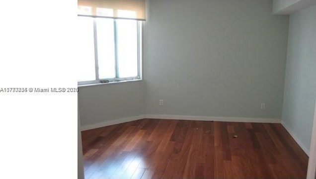 325 S Biscayne Blvd Unit 3822, Miami, FL 33131 - empty room with baseboards and dark wood finished floors