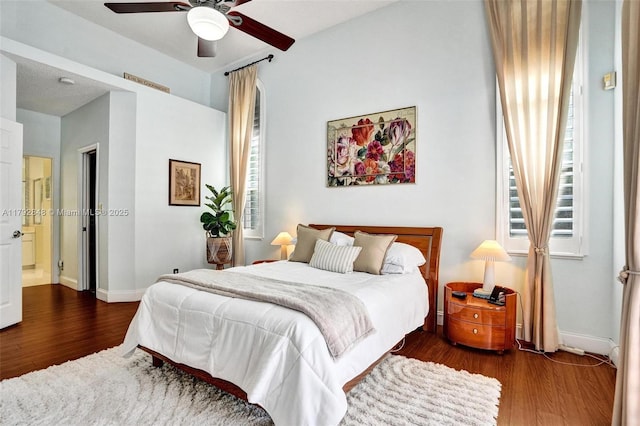 bedroom featuring baseboards, ceiling fan, and wood finished floors