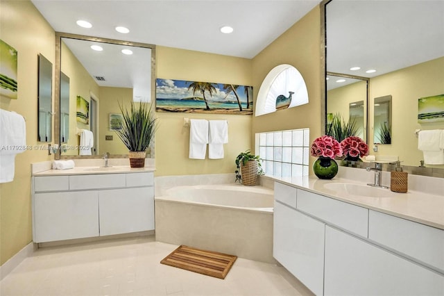 bathroom with recessed lighting and a sink