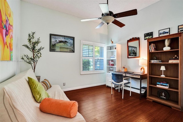office space featuring baseboards, ceiling fan, vaulted ceiling, and wood finished floors