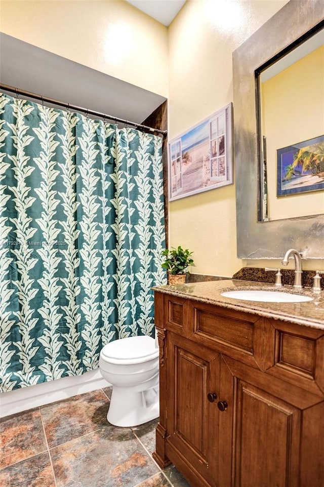 bathroom with vanity, toilet, and a shower with curtain
