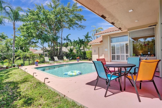 view of pool with a yard, fence, a patio area, and a fenced in pool
