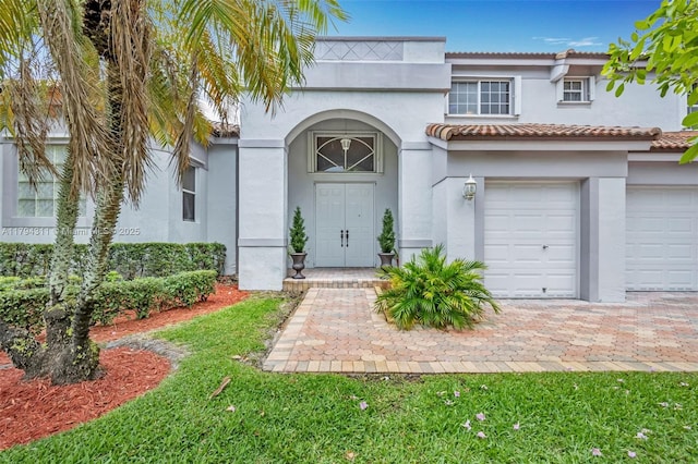 4123 W Lake Estates Dr, Davie, FL 33328 - view of front of property featuring stucco siding, a tile roof, and an attached garage