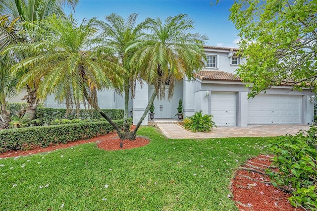 4123 W Lake Estates Dr, Davie, FL 33328 - view of front of home featuring stucco siding, a tile roof, a front lawn, driveway, and a garage