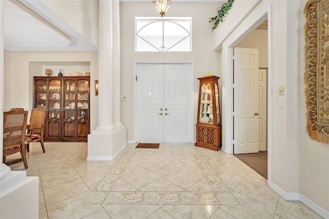 4123 W Lake Estates Dr, Davie, FL 33328 - foyer featuring light tile patterned floors, decorative columns, and a high ceiling
