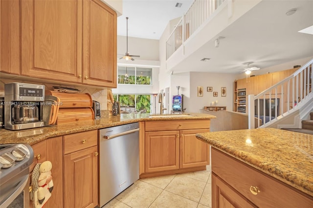 4123 W Lake Estates Dr, Davie, FL 33328 - kitchen with dishwasher, ceiling fan, range, light stone countertops, and a towering ceiling