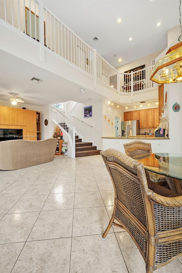 4123 W Lake Estates Dr, Davie, FL 33328 - living room featuring a towering ceiling, stairway, recessed lighting, light tile patterned flooring, and a ceiling fan