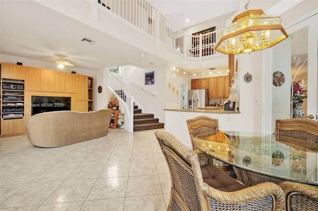 4123 W Lake Estates Dr, Davie, FL 33328 - dining space featuring a high ceiling, stairs, light tile patterned floors, ceiling fan, and a chandelier