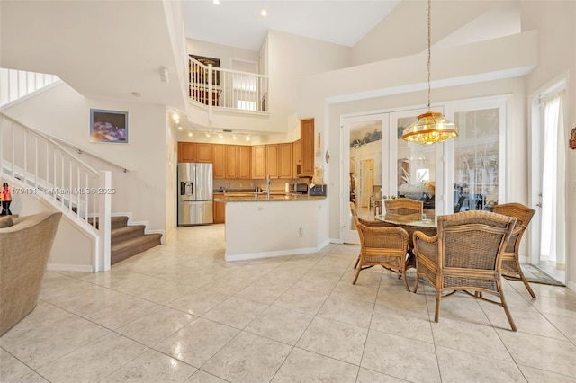 4123 W Lake Estates Dr, Davie, FL 33328 - dining room with stairs, high vaulted ceiling, light tile patterned floors, and a chandelier