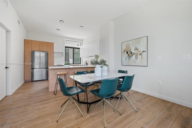 dining space featuring baseboards, recessed lighting, light wood finished floors, and visible vents