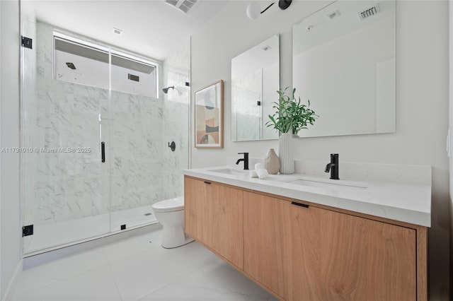 bathroom featuring double vanity, toilet, a marble finish shower, and a sink