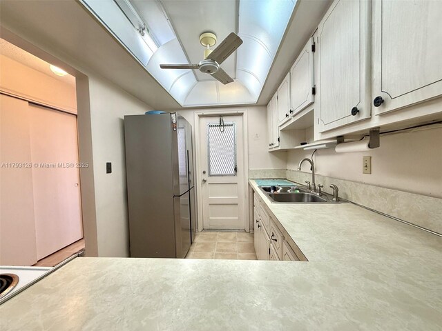 2301 NE 14th St Cswy Unit 201E, Pompano Beach, FL 33062 - kitchen with a sink, light countertops, freestanding refrigerator, a ceiling fan, and light tile patterned floors