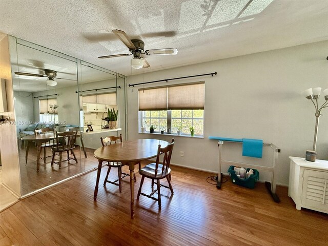 2301 NE 14th St Cswy Unit 201E, Pompano Beach, FL 33062 - dining space with a textured ceiling, ceiling fan, and wood finished floors