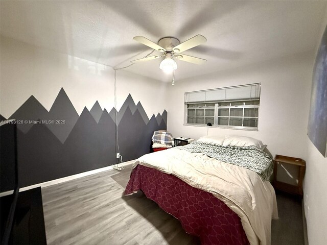 2301 NE 14th St Cswy Unit 201E, Pompano Beach, FL 33062 - bedroom featuring baseboards, ceiling fan, and wood finished floors