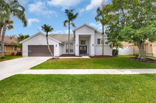 7649 Briar Cliff Cir, Lake Worth, FL 33467 - view of front of house with stucco siding, an attached garage, and concrete driveway