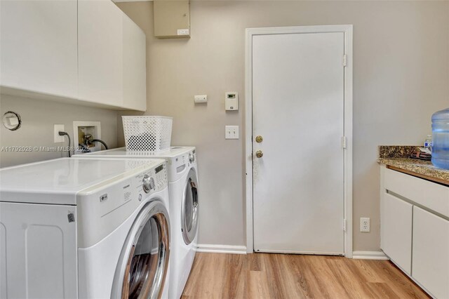 7649 Briar Cliff Cir, Lake Worth, FL 33467 - laundry room with washing machine and dryer, light wood finished floors, baseboards, and cabinet space