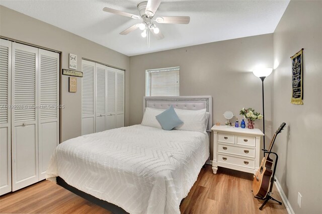 7649 Briar Cliff Cir, Lake Worth, FL 33467 - bedroom featuring multiple closets, wood finished floors, baseboards, and a ceiling fan