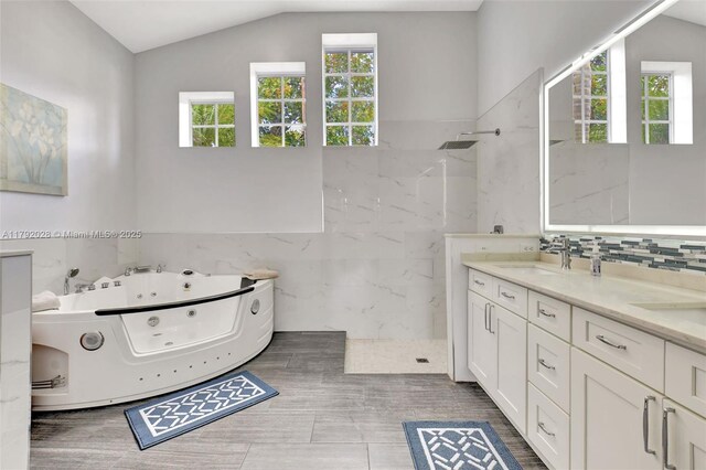 7649 Briar Cliff Cir, Lake Worth, FL 33467 - full bathroom featuring plenty of natural light, a marble finish shower, a jetted tub, tile walls, and double vanity