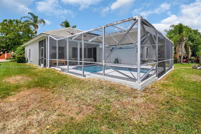 7649 Briar Cliff Cir, Lake Worth, FL 33467 - back of house featuring an outdoor pool, a yard, glass enclosure, and a patio area