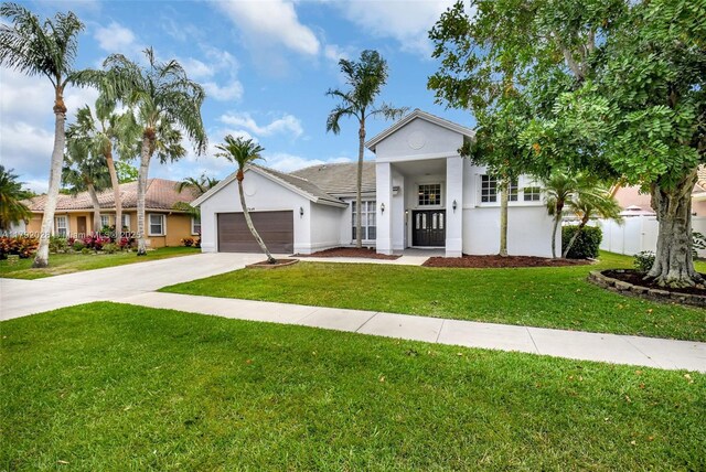 7649 Briar Cliff Cir, Lake Worth, FL 33467 - single story home featuring an attached garage, stucco siding, a front lawn, and driveway