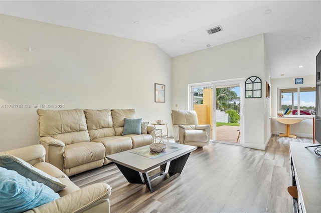 6340 NW 198th Ter, Hialeah, FL 33015 - living room featuring baseboards, high vaulted ceiling, light wood-style flooring, and visible vents