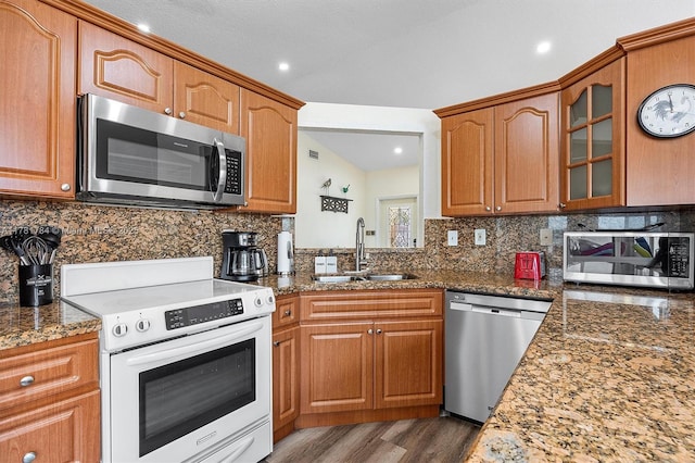 6340 NW 198th Ter, Hialeah, FL 33015 - kitchen with decorative backsplash, appliances with stainless steel finishes, wood finished floors, a sink, and glass insert cabinets