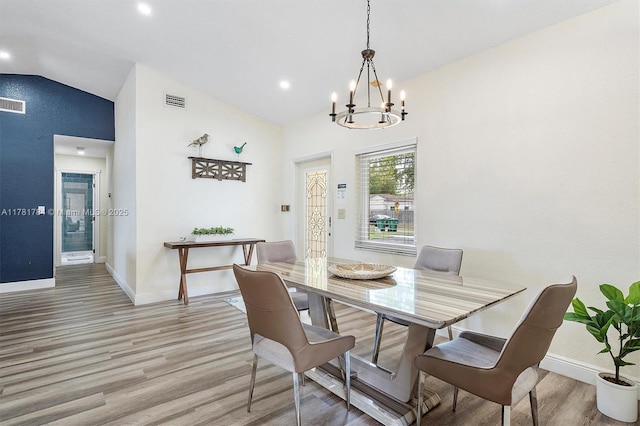 6340 NW 198th Ter, Hialeah, FL 33015 - dining area with an inviting chandelier, light wood-style flooring, baseboards, lofted ceiling, and visible vents