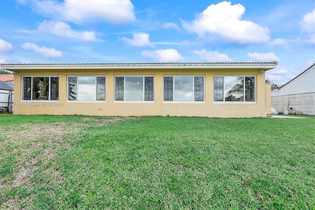 6340 NW 198th Ter, Hialeah, FL 33015 - back of property with a lawn, stucco siding, and fence