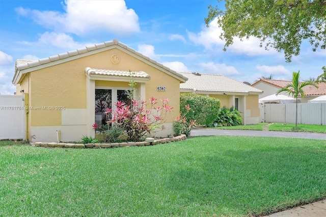 6340 NW 198th Ter, Hialeah, FL 33015 - ranch-style home featuring a front lawn, stucco siding, a tile roof, and fence