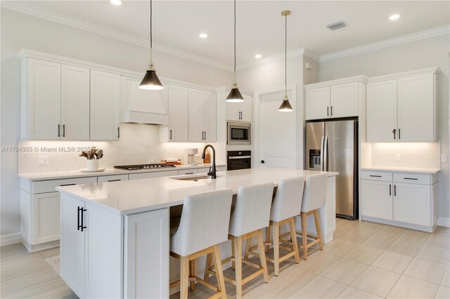 9657 Mosler Trl, Lake Worth, FL 33467 - kitchen with stainless steel appliances, a sink, an island with sink, backsplash, and a kitchen breakfast bar