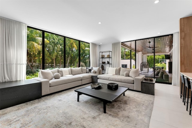 tiled living area featuring recessed lighting, a wall of windows, and a wealth of natural light