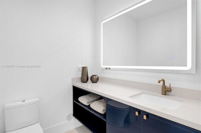 bathroom with toilet and vanity