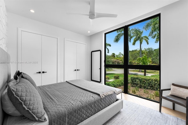 13180 Old Cutler Rd, Pinecrest, FL 33156 - bedroom featuring multiple closets, wood finished floors, recessed lighting, and ceiling fan