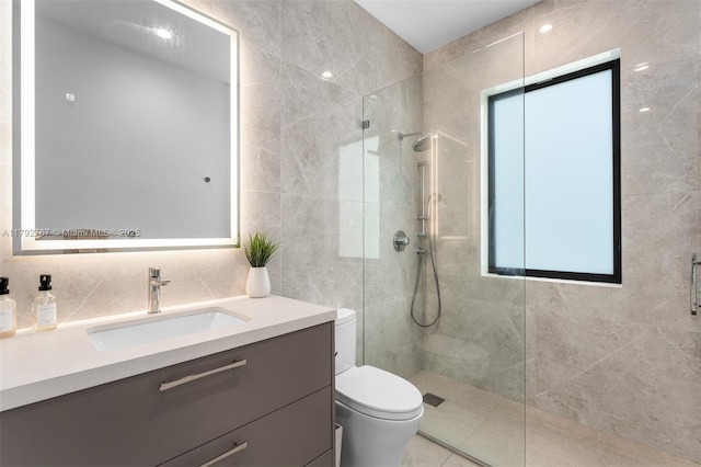 full bathroom featuring toilet, walk in shower, tile walls, and vanity