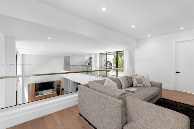living room with recessed lighting and wood finished floors