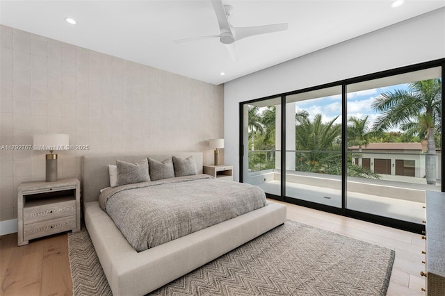 bedroom with access to outside, recessed lighting, and wood finished floors