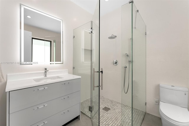full bath with vanity, a stall shower, and toilet