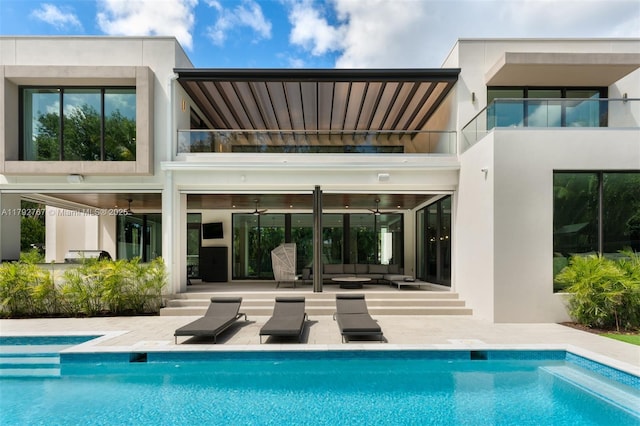 13180 Old Cutler Rd, Pinecrest, FL 33156 - rear view of property with an outdoor hangout area, a balcony, a patio, an outdoor pool, and stucco siding