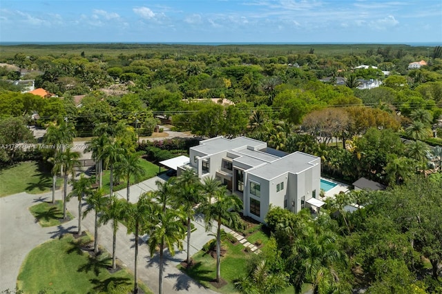 bird's eye view with a wooded view