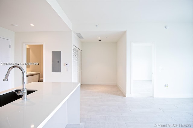 2000 Metropica Way Unit 615, Sunrise, FL 33323 - kitchen featuring electric panel, light countertops, recessed lighting, baseboards, and a sink