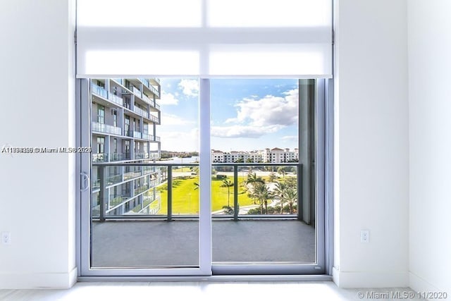 2000 Metropica Way Unit 615, Sunrise, FL 33323 - doorway with healthy amount of natural light and baseboards