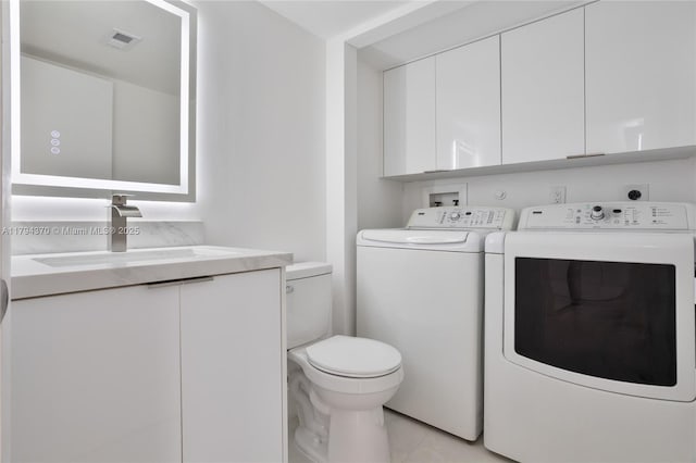 853 SW 118th Ter, Davie, FL 33325 - bathroom with tile patterned flooring, visible vents, vanity, toilet, and separate washer and dryer