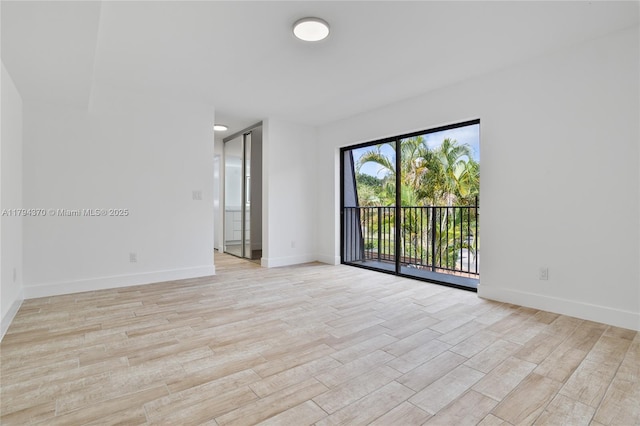 853 SW 118th Ter, Davie, FL 33325 - empty room with baseboards and light wood-style flooring