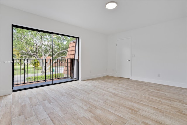 853 SW 118th Ter, Davie, FL 33325 - unfurnished room featuring baseboards and light wood finished floors