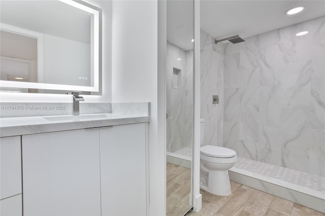 853 SW 118th Ter, Davie, FL 33325 - bathroom featuring vanity, wood finished floors, toilet, recessed lighting, and a marble finish shower