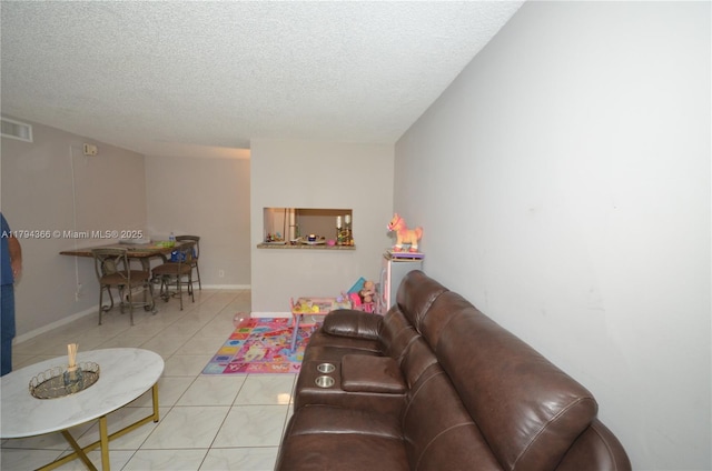 1004 Twin Lakes Dr Unit 1004, Coral Springs, FL 33071 - tiled living area featuring a textured ceiling, visible vents, and baseboards