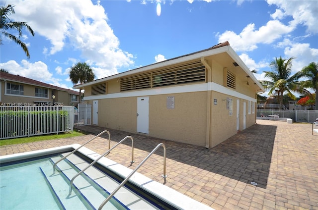 1004 Twin Lakes Dr Unit 1004, Coral Springs, FL 33071 - back of property featuring fence, a patio area, and stucco siding