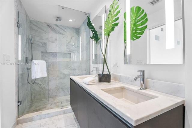 bathroom featuring visible vents, double vanity, marble finish floor, a sink, and a marble finish shower